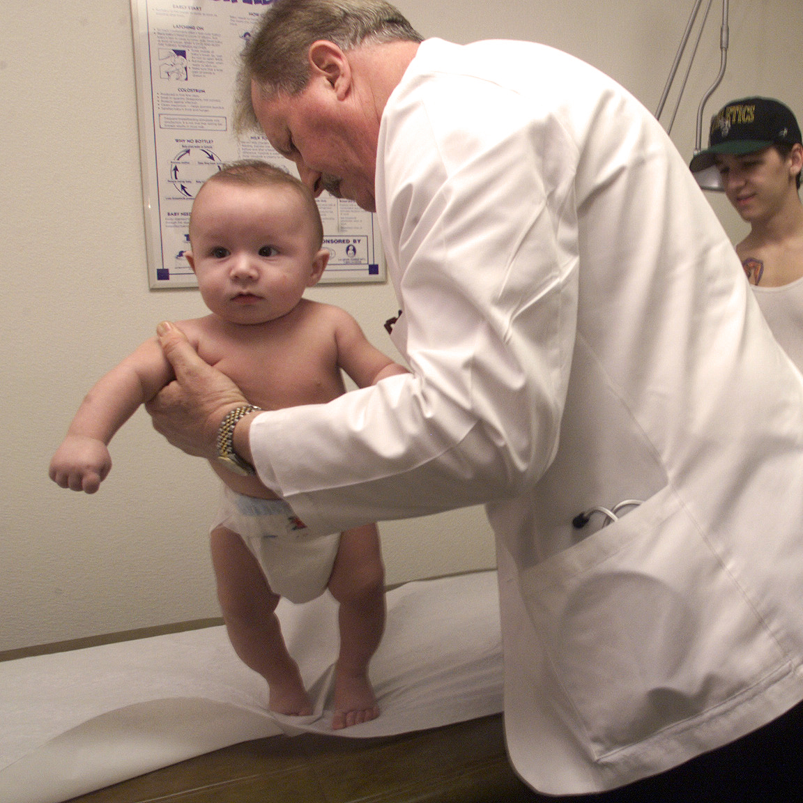 John Betz, an Othello physician's assistant, does a well-infant examination on 4-month old Dominic Sheriff as his parents, Kyrone and Lisa Sheriff, watch. The Washington Rural Health Association has named Betz and colleague Paul Snyder practitioners of the year.