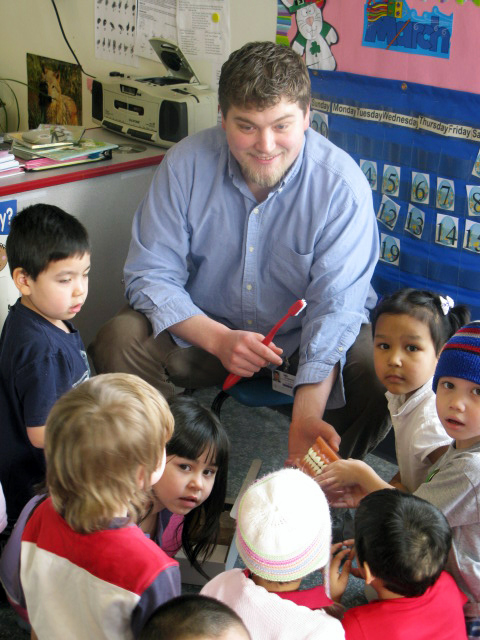 DHAT Ben Stewart teaches Alaskan children proper dental hygiene during a Southcentral Foundation Head Start session.