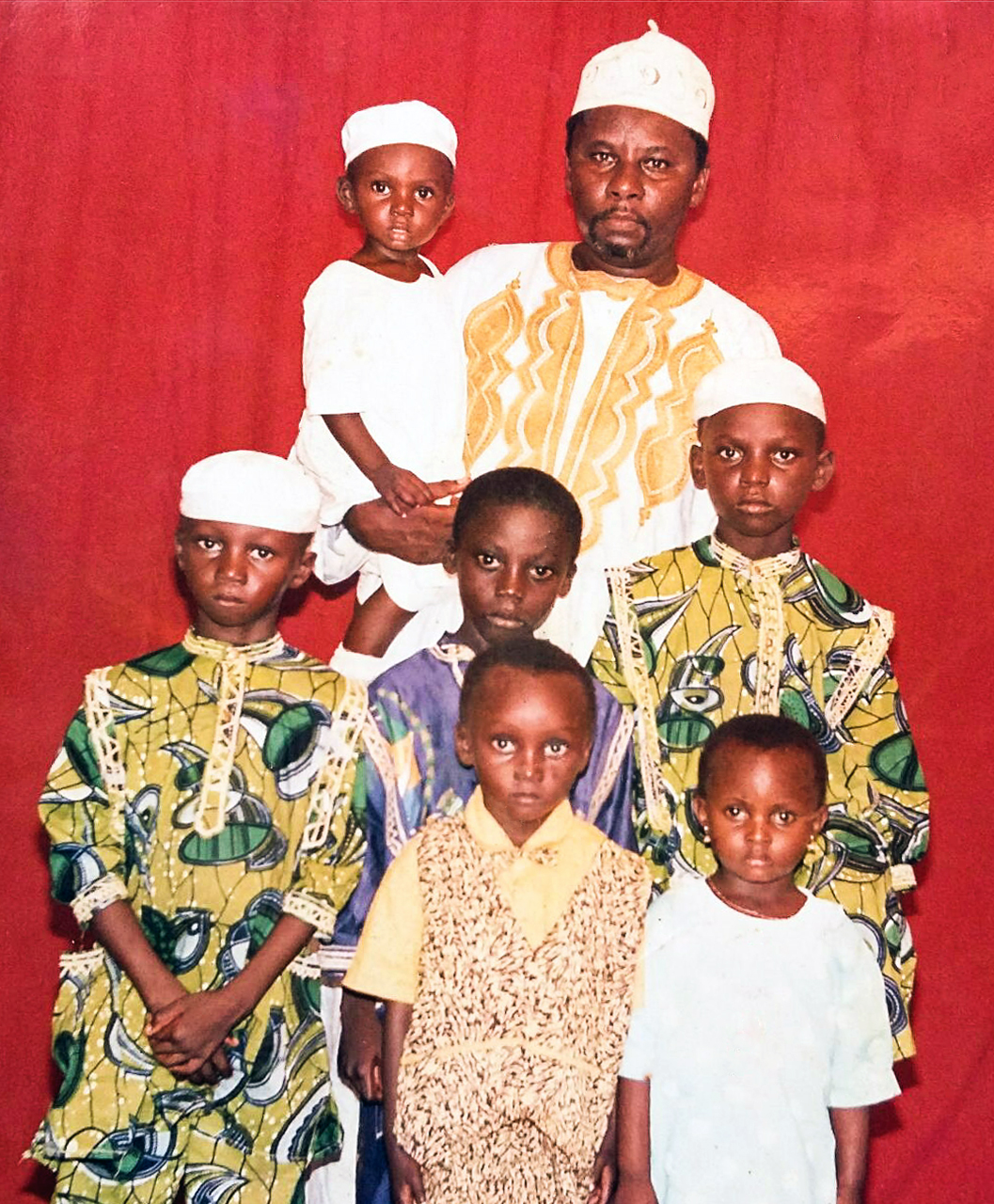 A young Ismail Jatta with his father, three brothers and cousins in his native Gambia, West Africa. Ismail is the tallest at the right.
